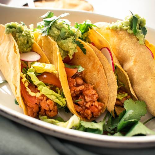 Ground turkey tacos in crispy baked tortillas with salsa, lettuce, radishes, and guacamole.