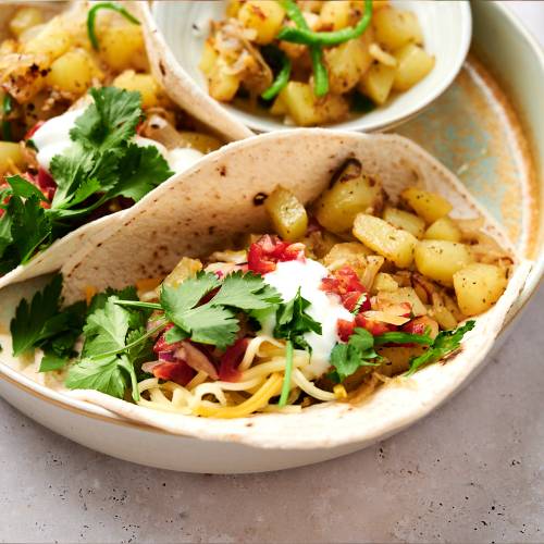 Potato green chile tacos with chopped potatoes, poblano peppers, onions, and salsa served in corn tortillas.