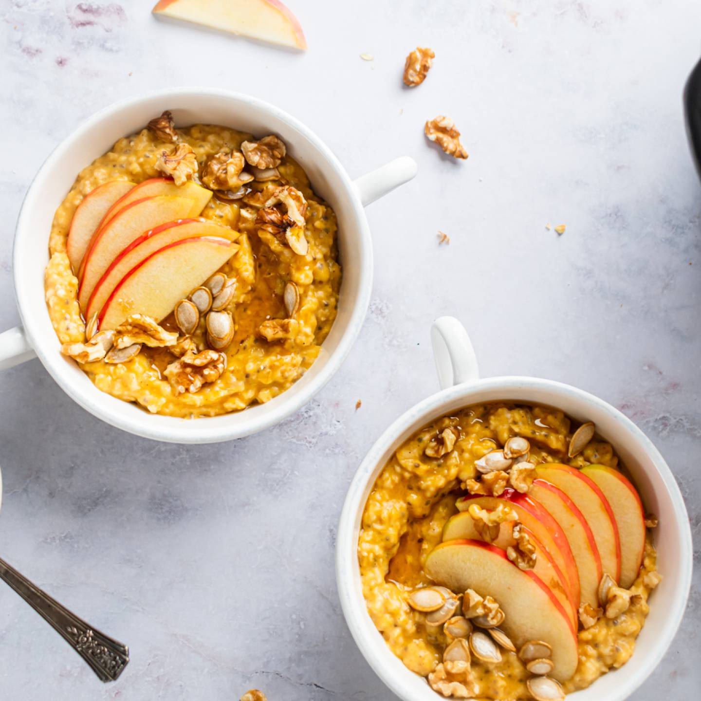 Slow cooker steel cut oatmeal with pumpkin pie spices on a plate with sliced banana.