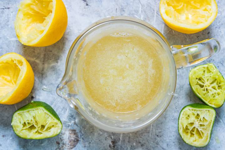 Lemon and lime juice mixed with honey in a glass jar.