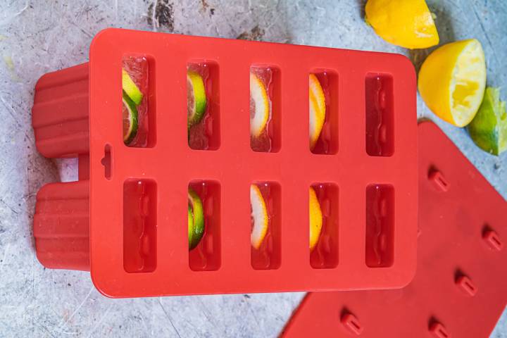 Lemon and lime juice in a red popsicle mold.