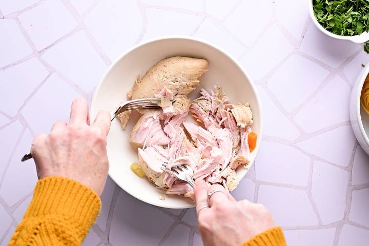 Turkey breast being shredded.