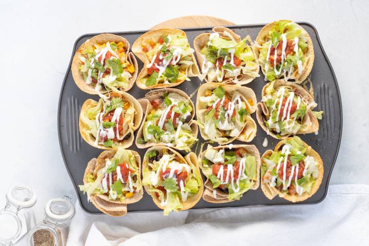 Crispy tortillas filled with black beans, cheese, lettuce, salsa, and sour cream.